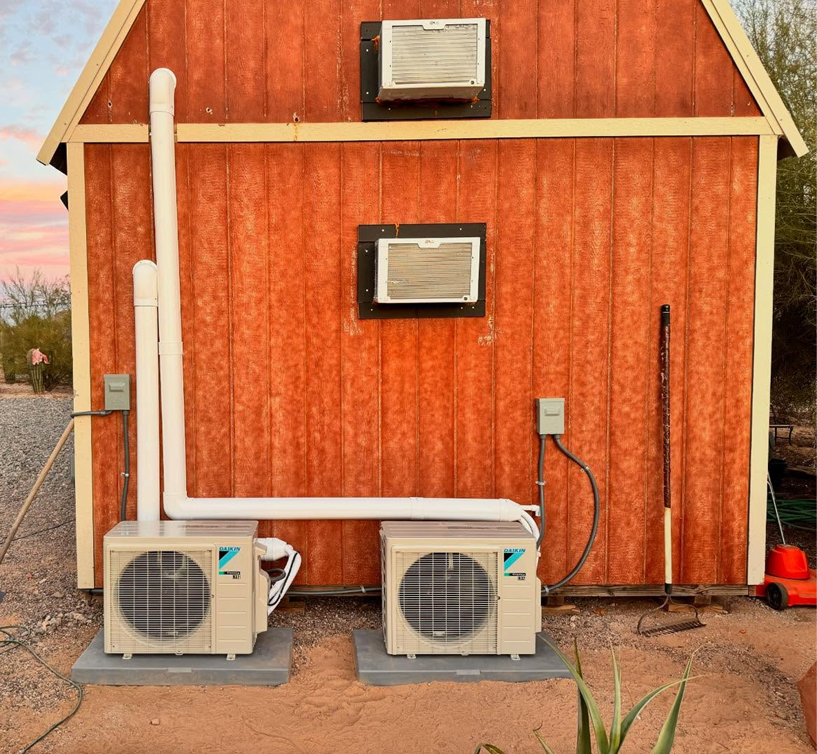 Red shed with two air conditioning units.
