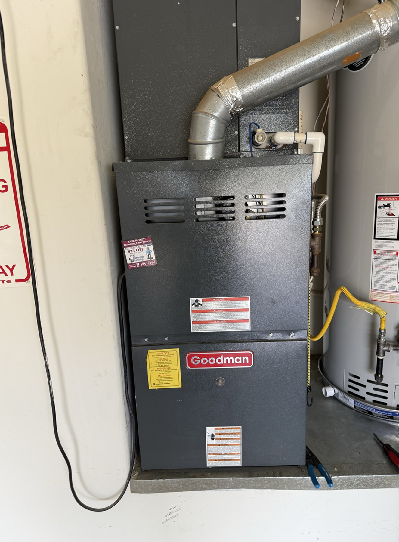 Goodman furnace unit installed in a space.
