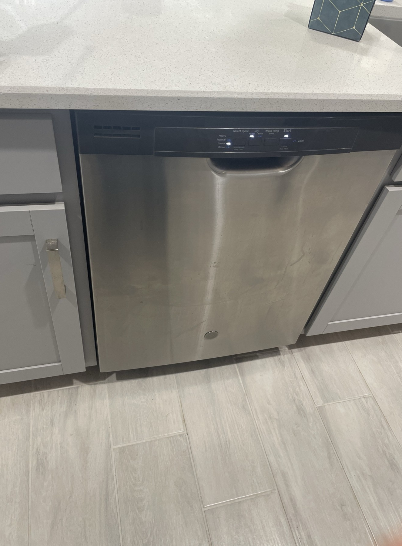 Stainless steel dishwasher in modern kitchen.