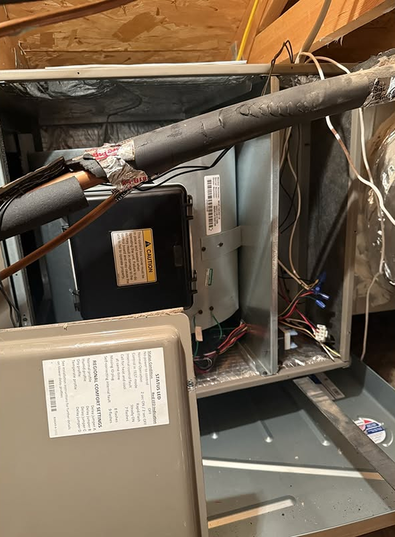 Open HVAC unit with exposed wiring.
